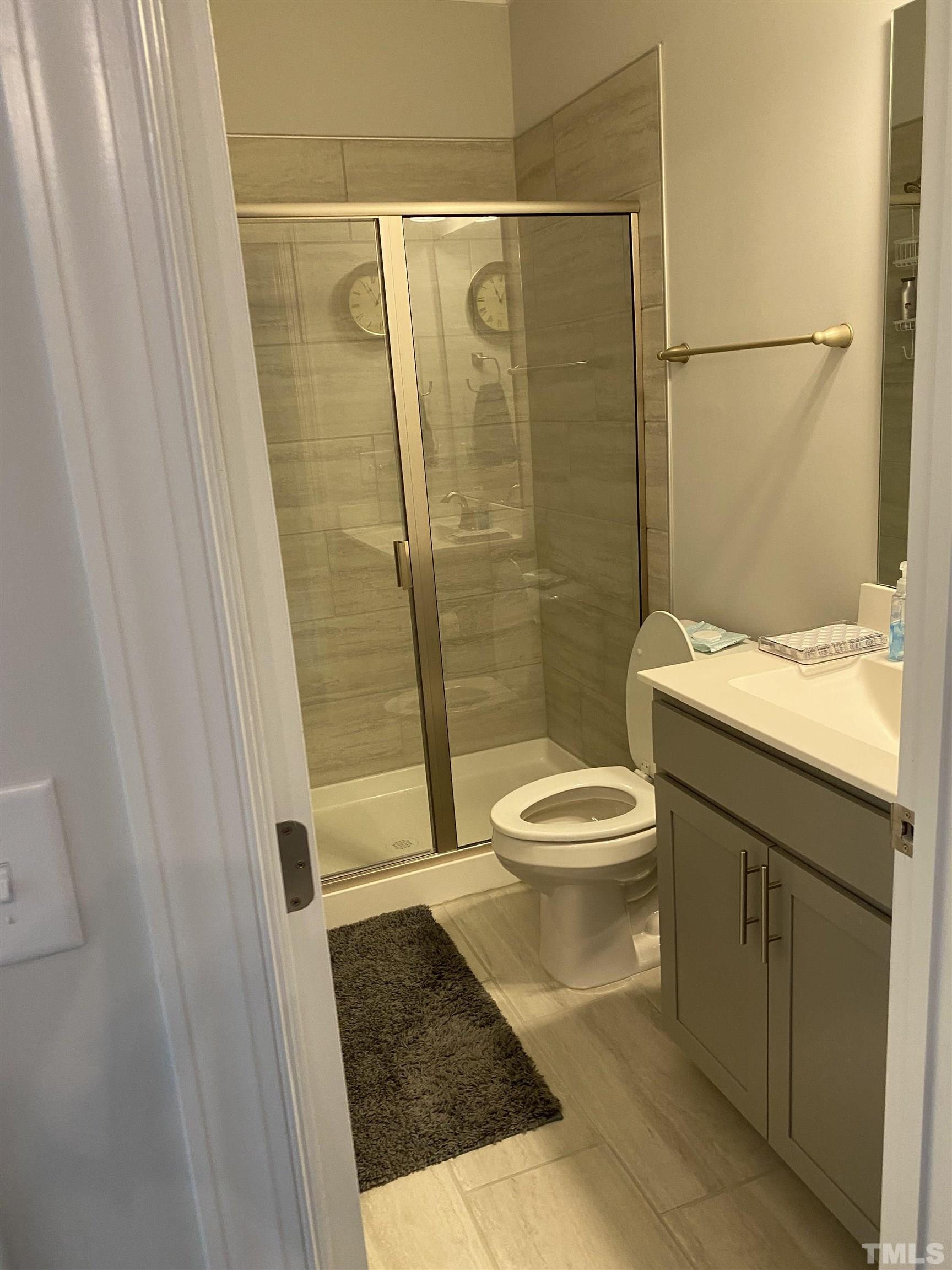 107 Ivory Lane Raleigh, NC 27610 - Photo 5 of 25 a bathroom with a granite countertop toilet a sink a shower and a bathtub