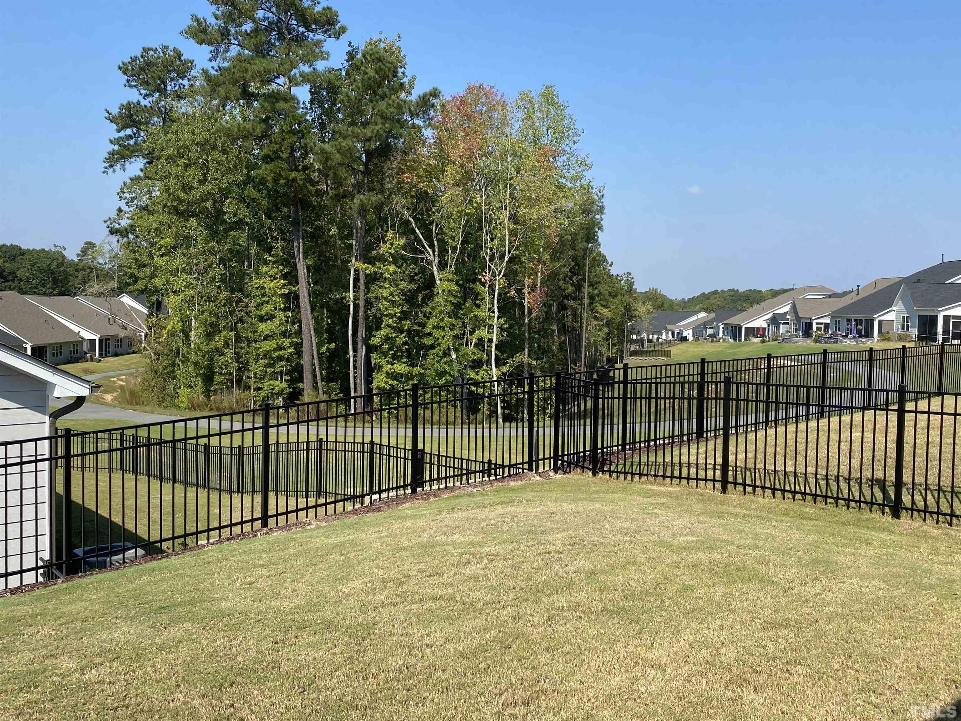 107 Ivory Lane Raleigh, NC 27610 - Photo 9 of 25 a view of outdoor space with a fence and trees