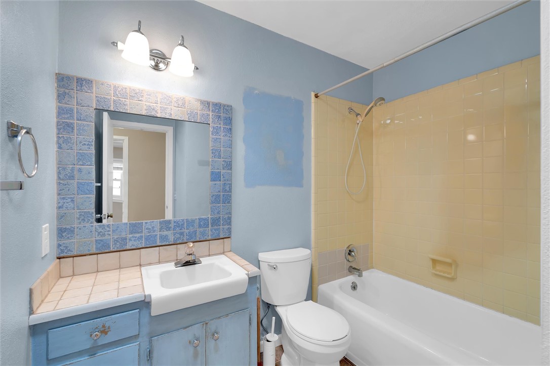 106 Mitchell Avenue Clemson, SC 29631 - Photo 19 of 31 This bathroom features a sink, toilet, and bathtub with tiled walls.