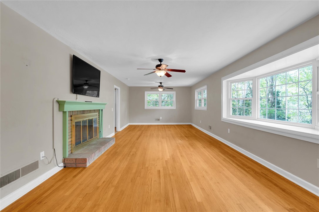 106 Mitchell Avenue Clemson, SC 29631 - Photo 2 of 31 This bright living space features polished hardwood floors, large windows, and a classic fireplace.