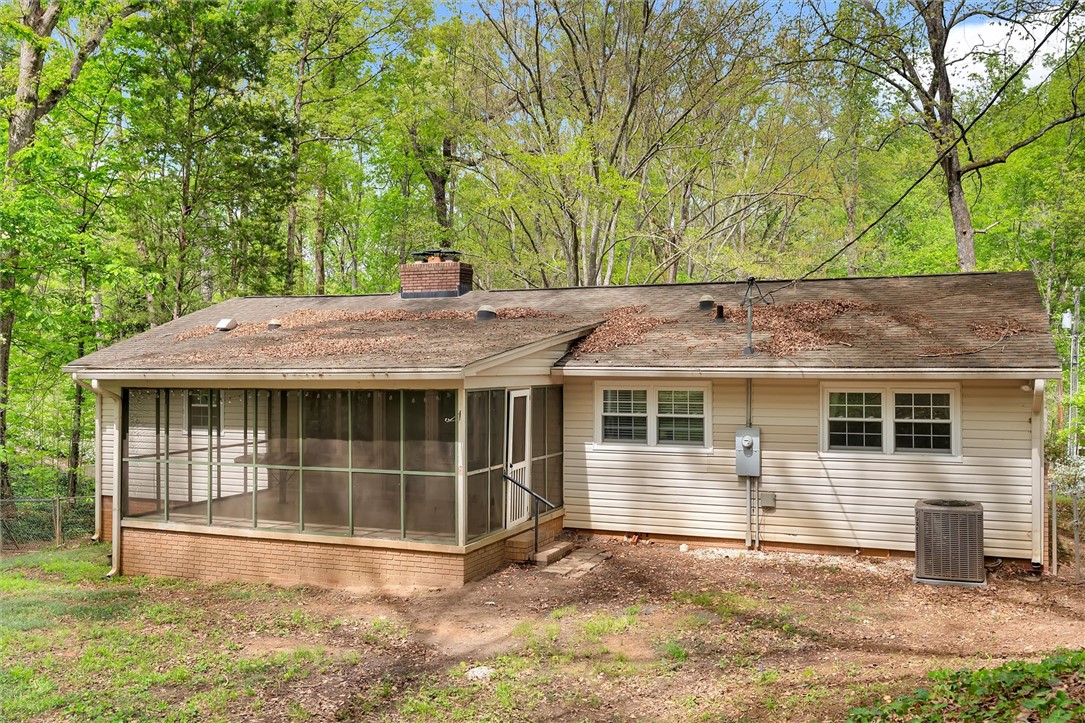 106 Mitchell Avenue Clemson, SC 29631 - Photo 24 of 31 This residence features a screened porch and a lush, verdant backdrop.