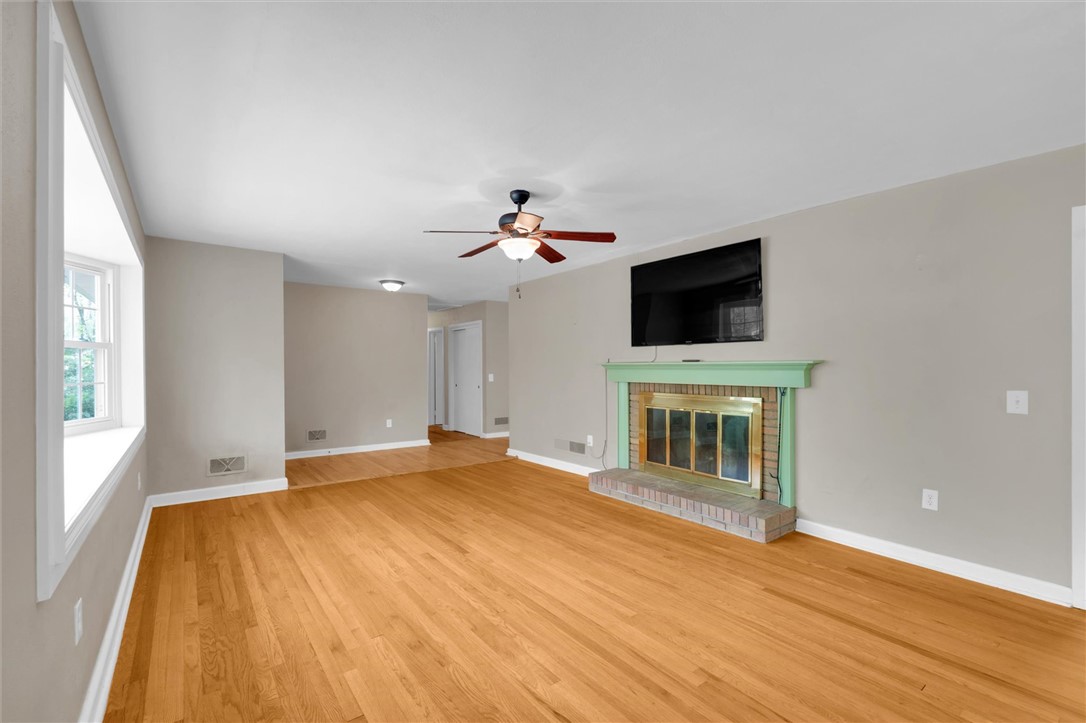 106 Mitchell Avenue Clemson, SC 29631 - Photo 4 of 31 This expansive room offers gleaming hardwood floors and a cozy fireplace, perfect for gatherings.