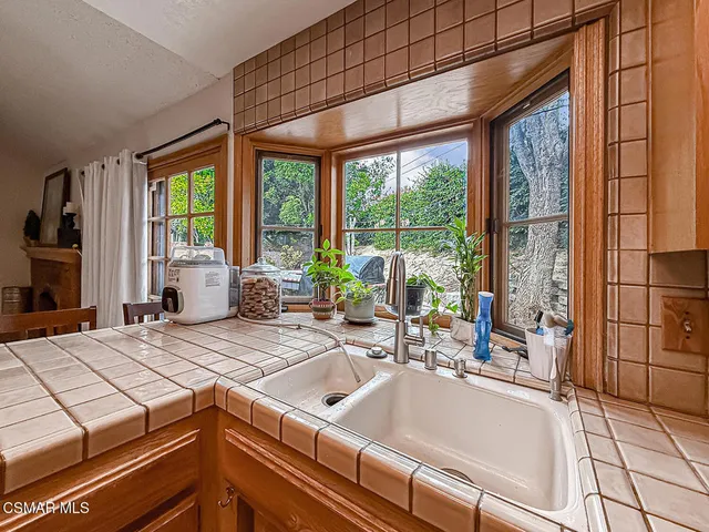 a kitchen that has a sink and a stove