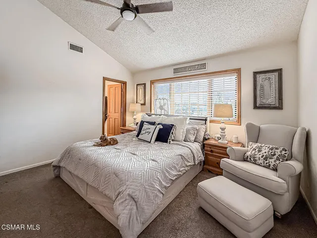 a bedroom with bed and window