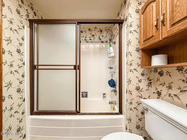a bathroom with a shower and a toilet
