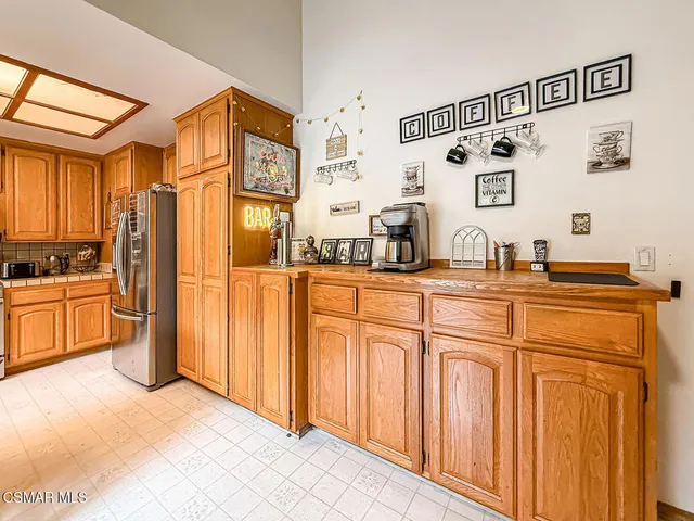 a kitchen with stainless steel appliances a refrigerator and cabinets