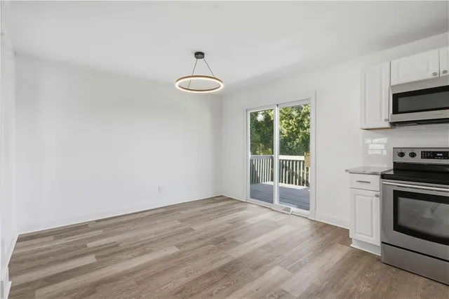 a view of a kitchen with a sink a microwave and window