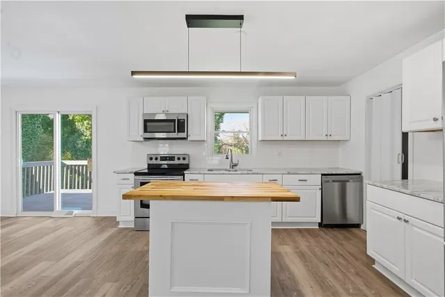 a kitchen with a stove a sink and a refrigerator