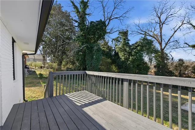 a balcony with wooden floor and fence