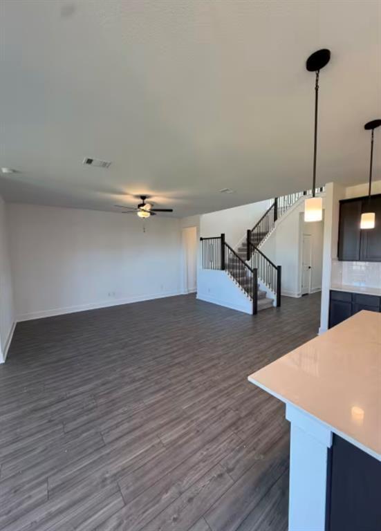 151 Sincere Drive Kyle, TX 78640 - Photo 3 of 15 a view of a room with wooden floor and a ceiling fan