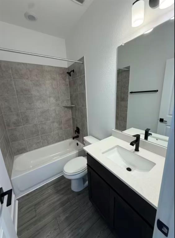 151 Sincere Drive Kyle, TX 78640 - Photo 10 of 15 a bathroom with a sink a toilet a mirror and bathtub