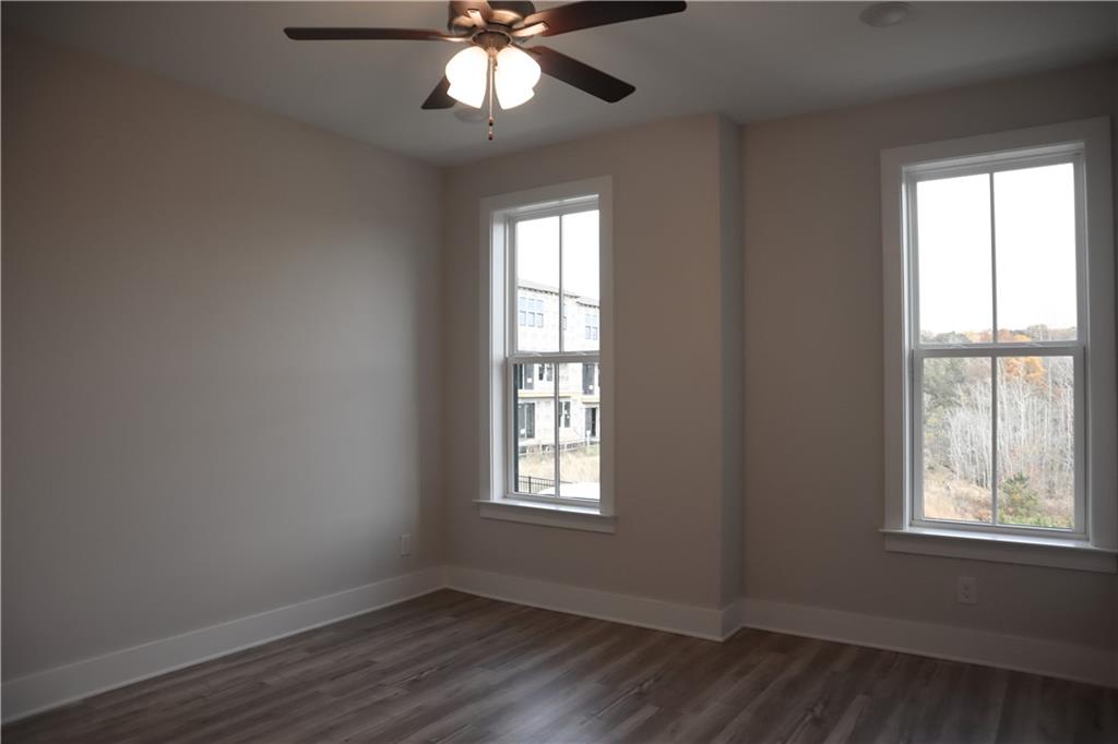 692 Urban Grange Way Suwanee, GA 30024 - Photo 15 of 23 a view of an empty room with wooden floor and a window