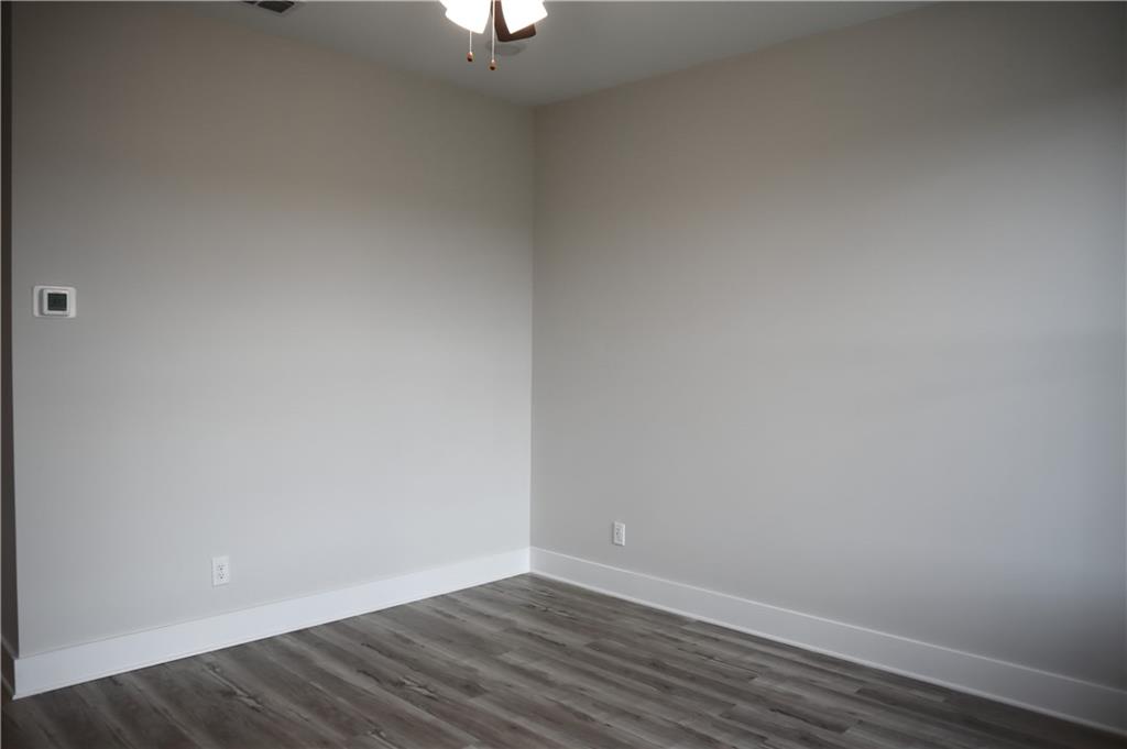 692 Urban Grange Way Suwanee, GA 30024 - Photo 17 of 23 a view of an empty room with wooden floor and a window