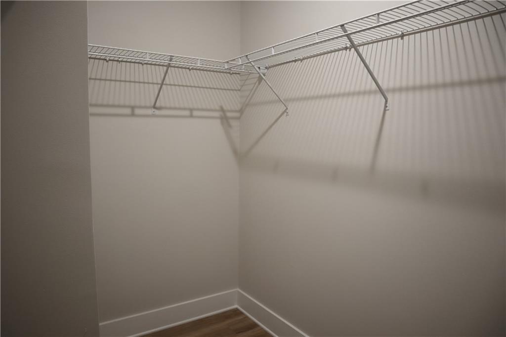 692 Urban Grange Way Suwanee, GA 30024 - Photo 19 of 23 a view of a room with racks on the wall