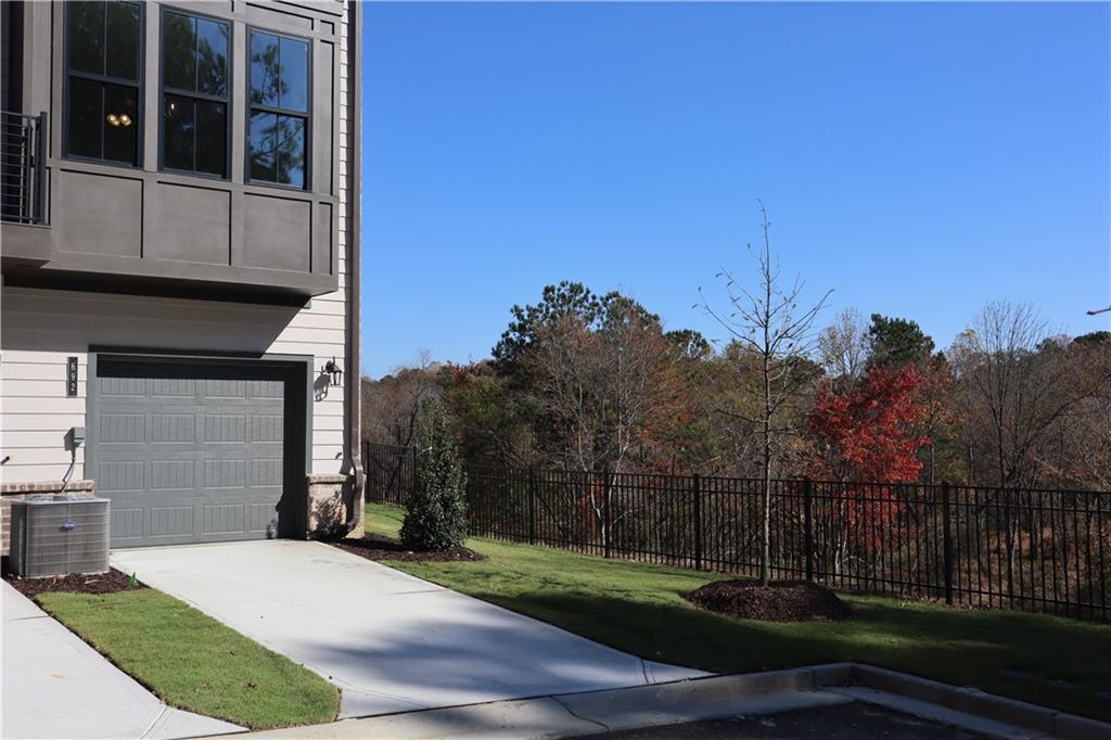 692 Urban Grange Way Suwanee, GA 30024 - Photo 23 of 23 a front view of a house with a yard