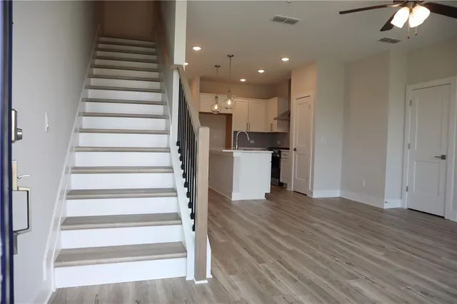 a view of entryway and hall with wooden floor