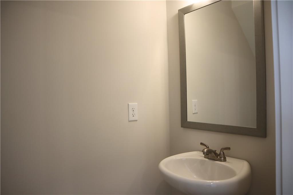 692 Urban Grange Way Suwanee, GA 30024 - Photo 4 of 23 a bathroom with a sink and a mirror