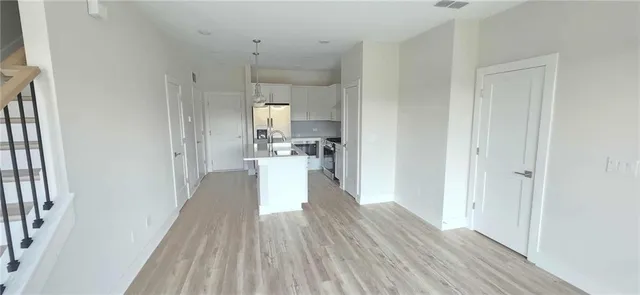 a view of a kitchen with wooden floor
