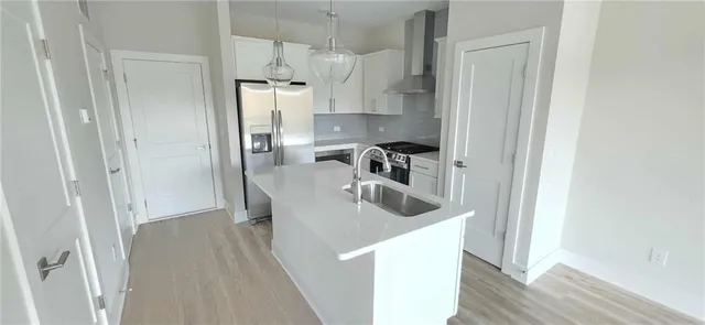 a kitchen with refrigerator and cabinets