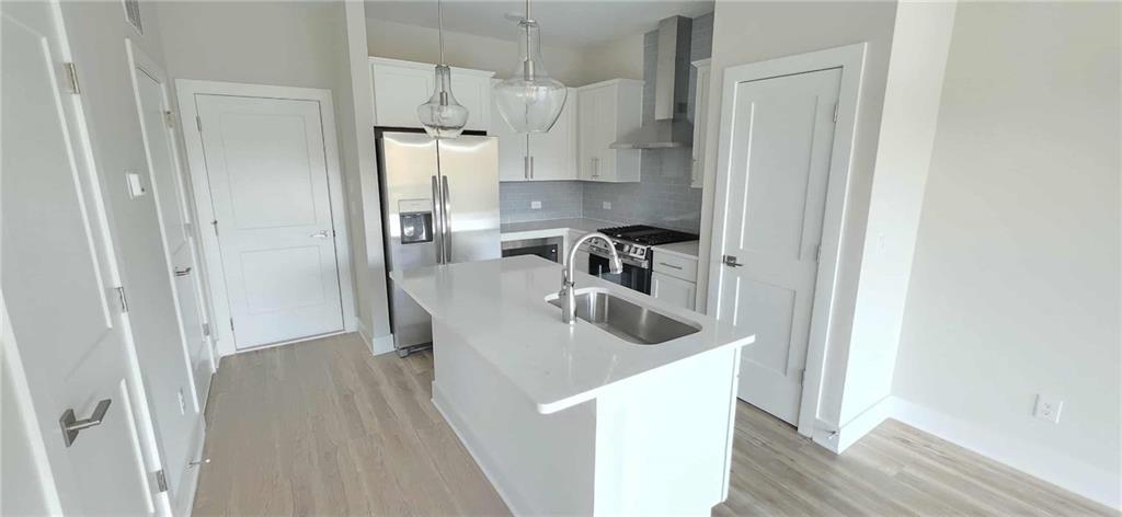 692 Urban Grange Way Suwanee, GA 30024 - Photo 8 of 23 a kitchen with refrigerator and cabinets