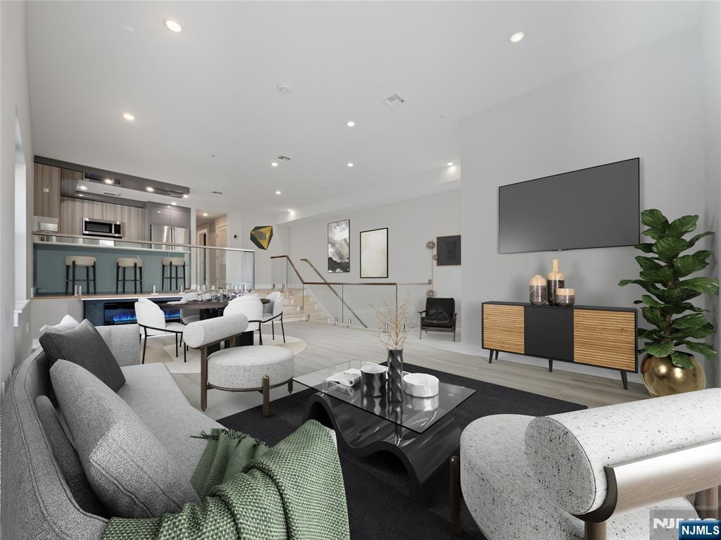 524 64th Street, Unit 2 West New York, NJ 07093 - Photo 12 of 18 a living room with furniture potted plant and a flat screen tv