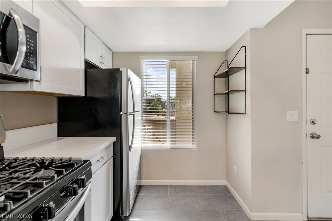 8070 West Russell Road, Unit 2006 Las Vegas, NV 89113 - Photo 5 of 24 A well-equipped kitchen space featuring modern appliances and light-filled windows.