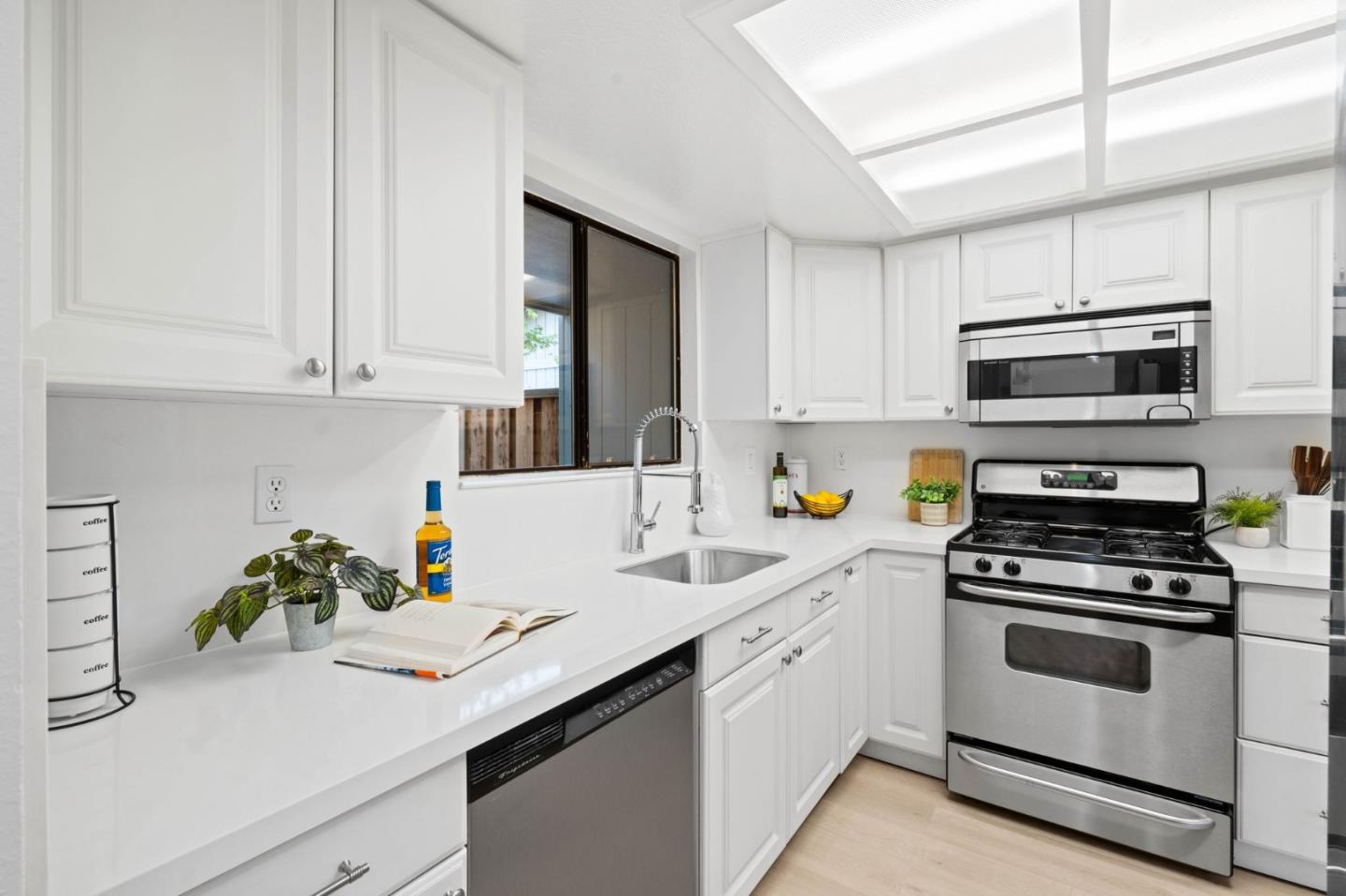 1165 Smith Avenue, Unit B Campbell, CA 95008 - Photo 16 of 46 a kitchen with kitchen island white cabinets appliances and a sink