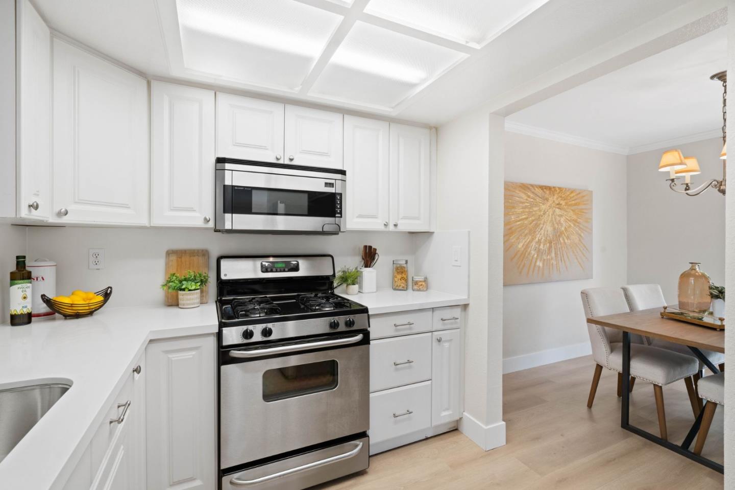 1165 Smith Avenue, Unit B Campbell, CA 95008 - Photo 17 of 46 a kitchen with stainless steel appliances a stove a sink cabinets and a window