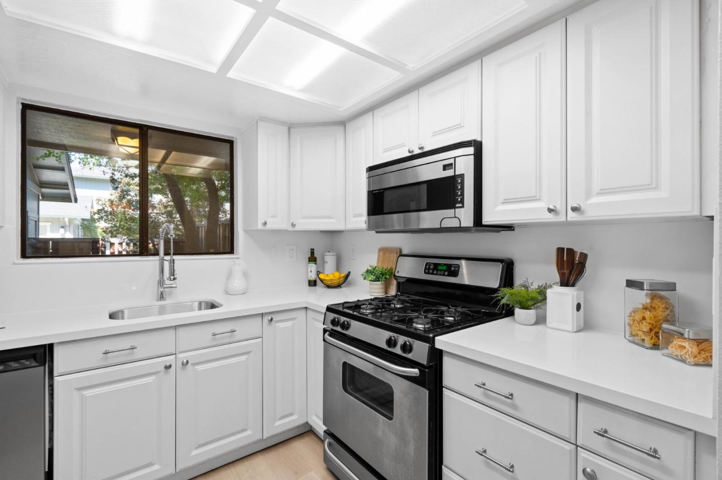 1165 Smith Avenue, Unit B Campbell, CA 95008 - Photo 18 of 46 a kitchen with a sink stove top oven and cabinets