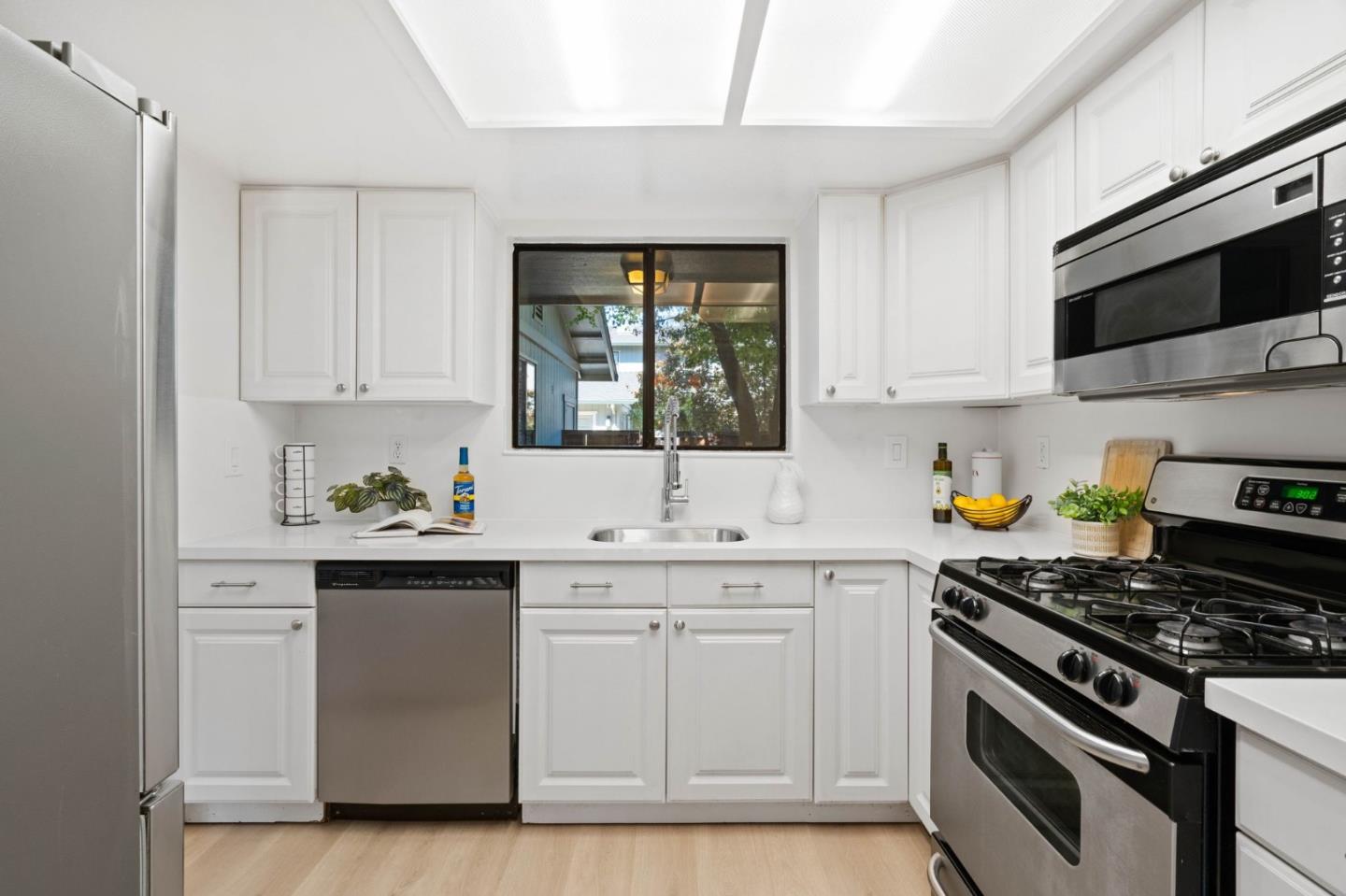 1165 Smith Avenue, Unit B Campbell, CA 95008 - Photo 19 of 46 a kitchen with stainless steel appliances a sink dishwasher stove and white cabinets