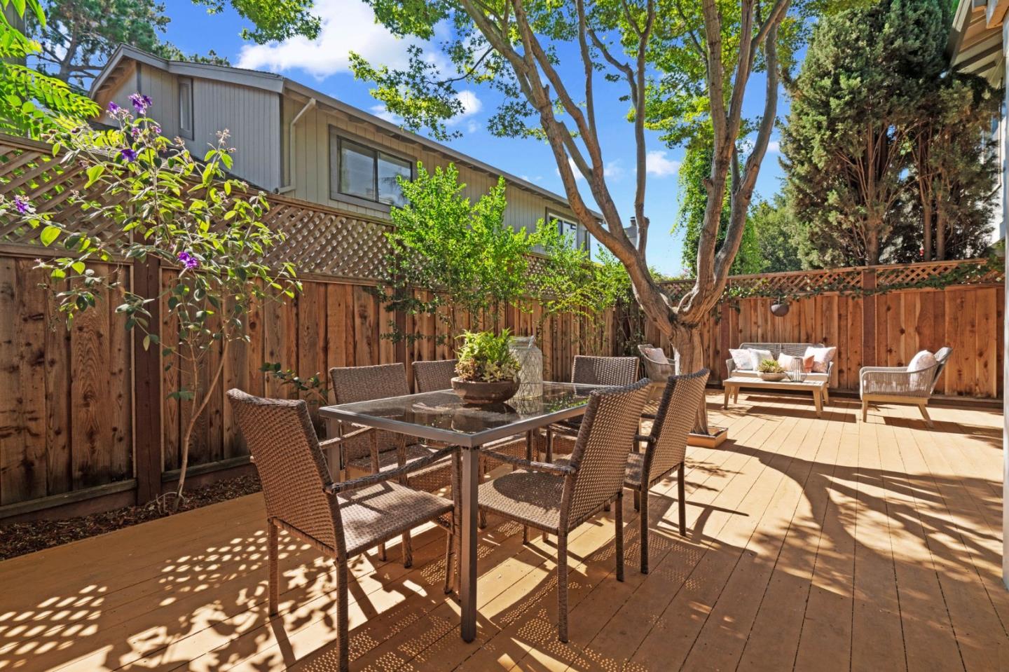 1165 Smith Avenue, Unit B Campbell, CA 95008 - Photo 44 of 46 a view of a patio with table and chairs and floor to ceiling window with wooden fence