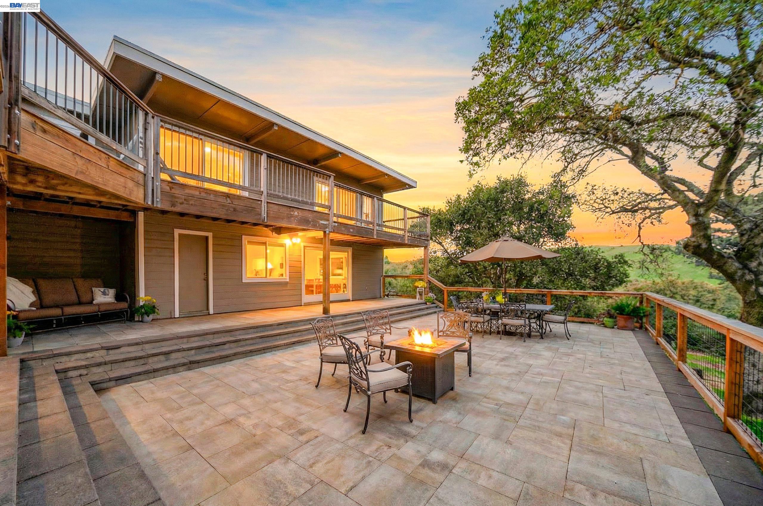 a view of a patio with table and chairs and wooden floor