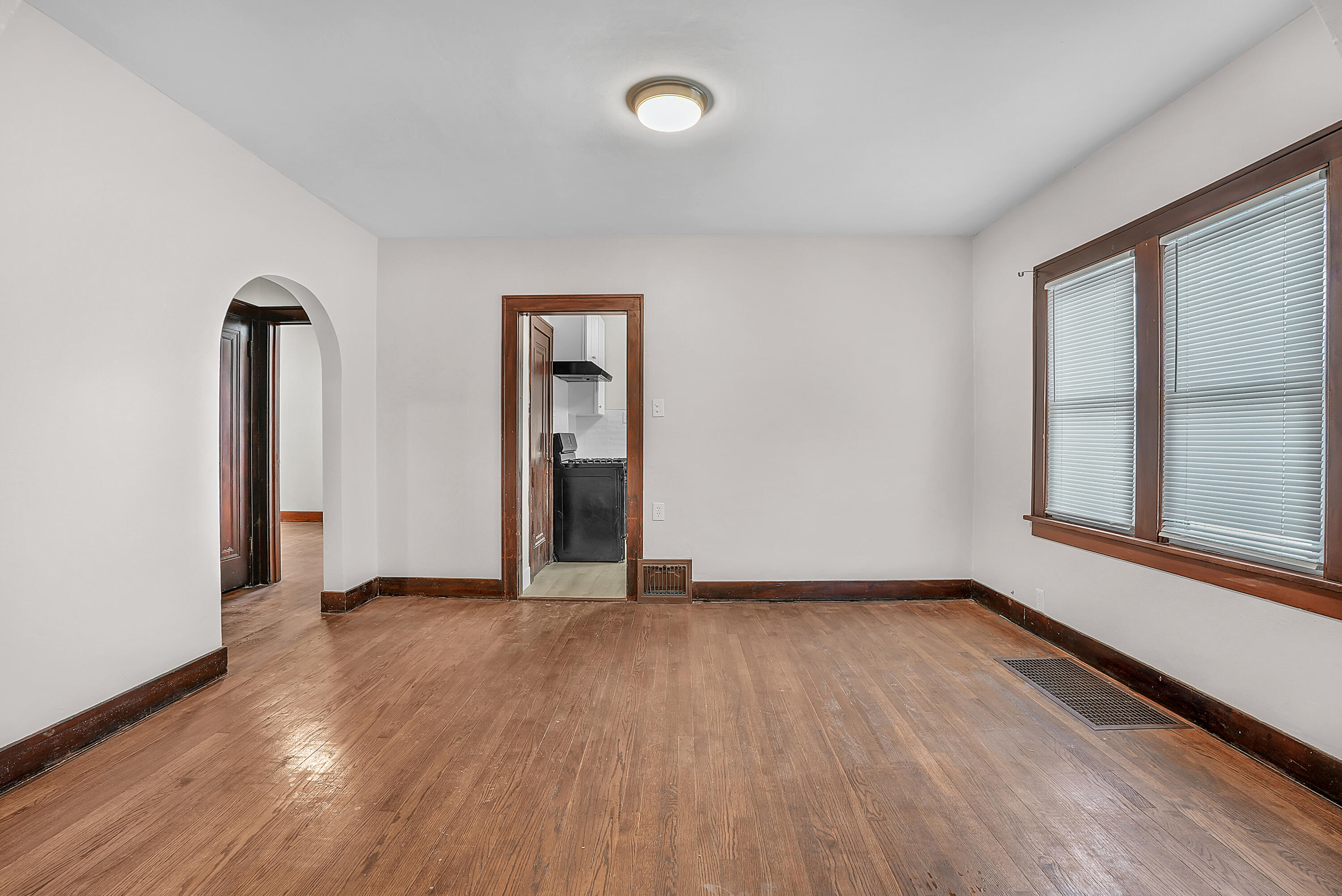 7511 Monroe Avenue Hammond, IN 46324 - Photo 5 of 20 an empty room with wooden floor and windows