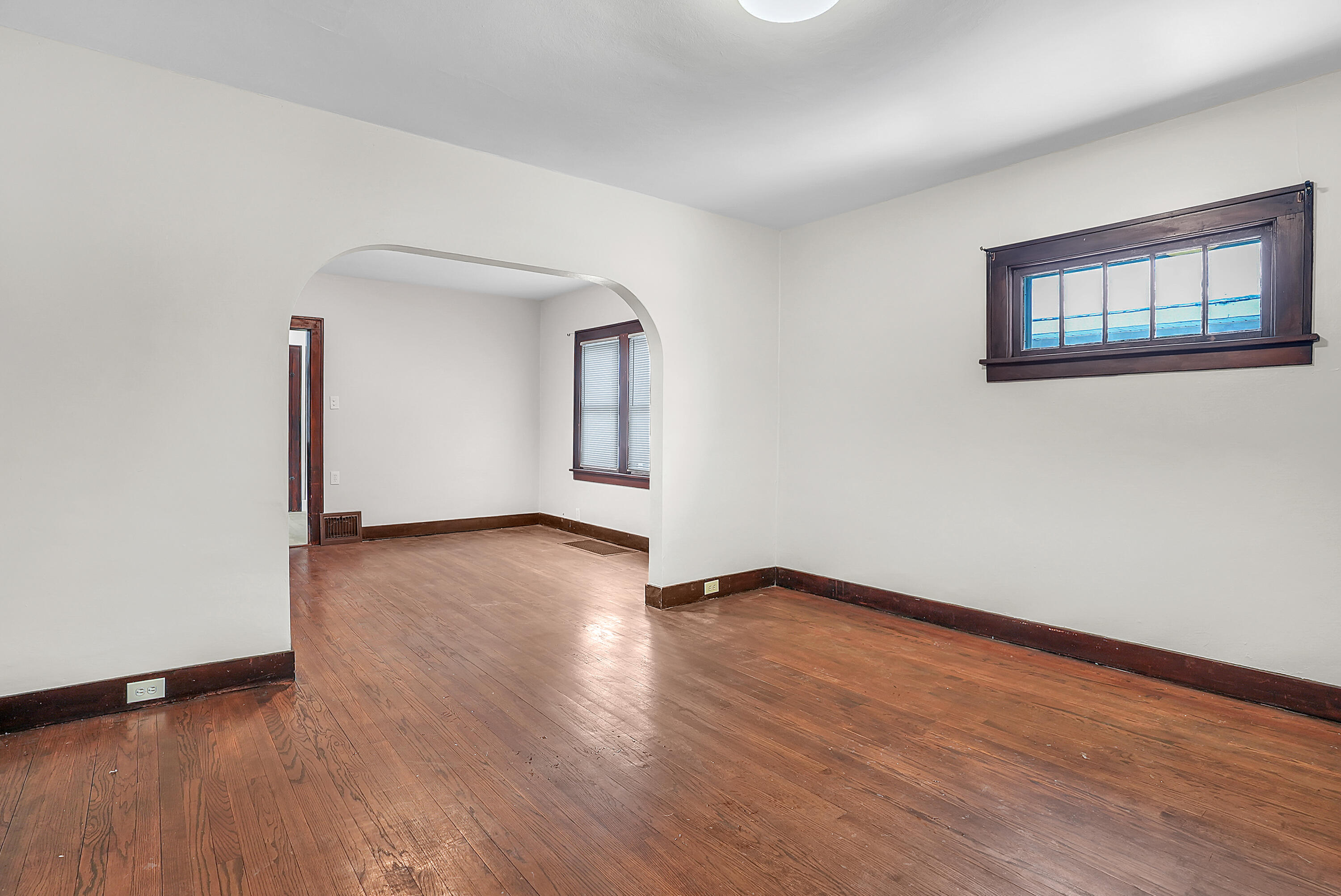 7511 Monroe Avenue Hammond, IN 46324 - Photo 7 of 20 an empty room with wooden floor and windows