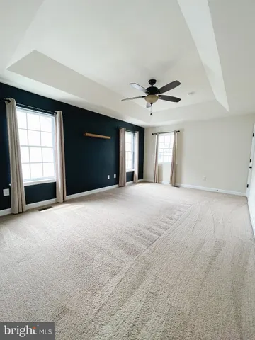 a view of a livingroom with a ceiling fan and window