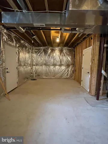 a view of wooden deck and lake with trees in the background
