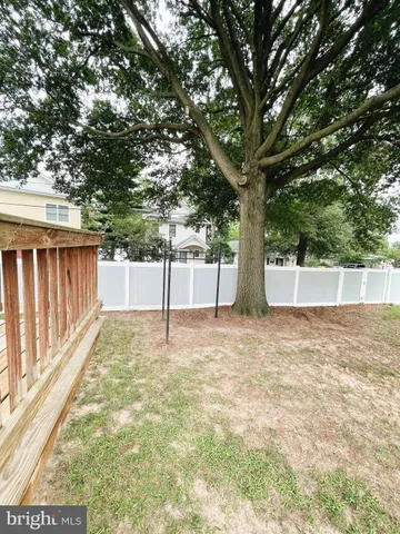 a view of a backyard with a garden and entertaining space