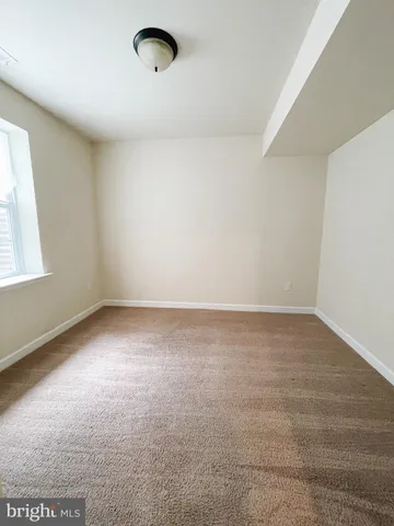 an empty room with a empty space and windows