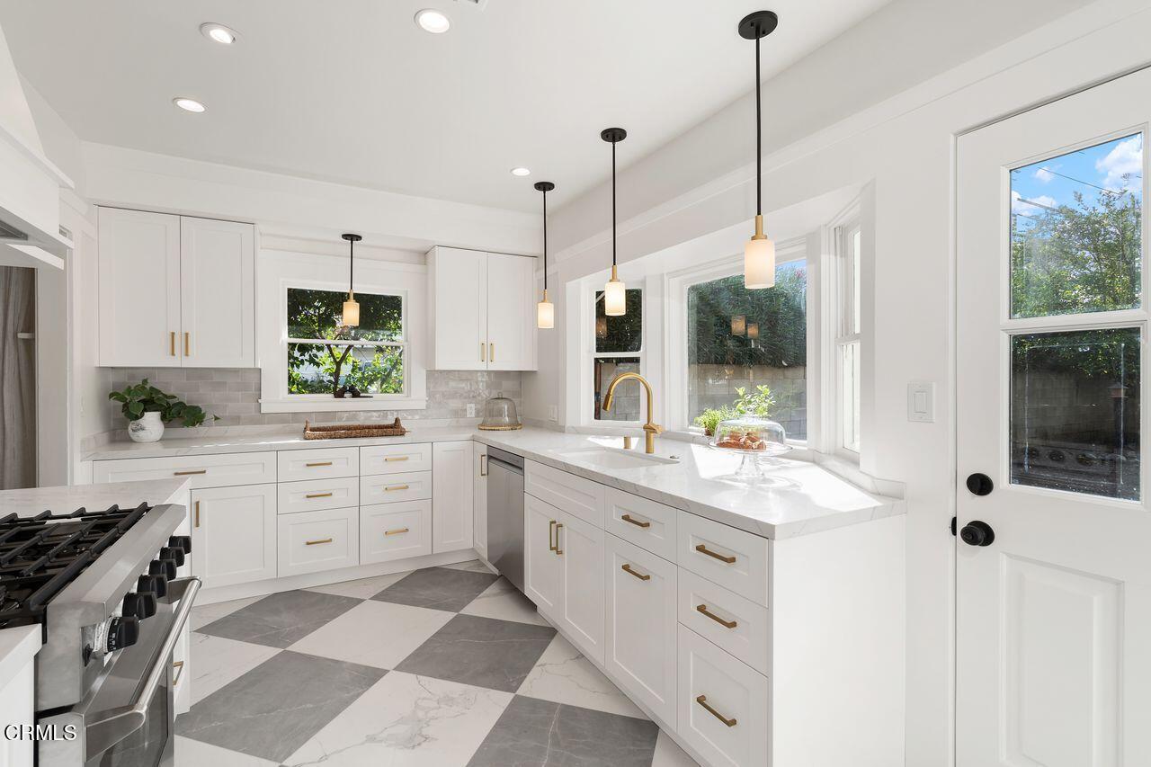114 West 3rd Street San Dimas, CA 91773 - Photo 11 of 23 a kitchen with white cabinets and appliances
