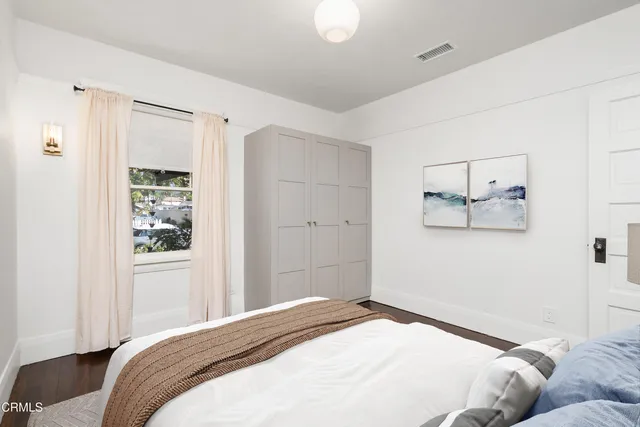 a bedroom with a large bed and a window