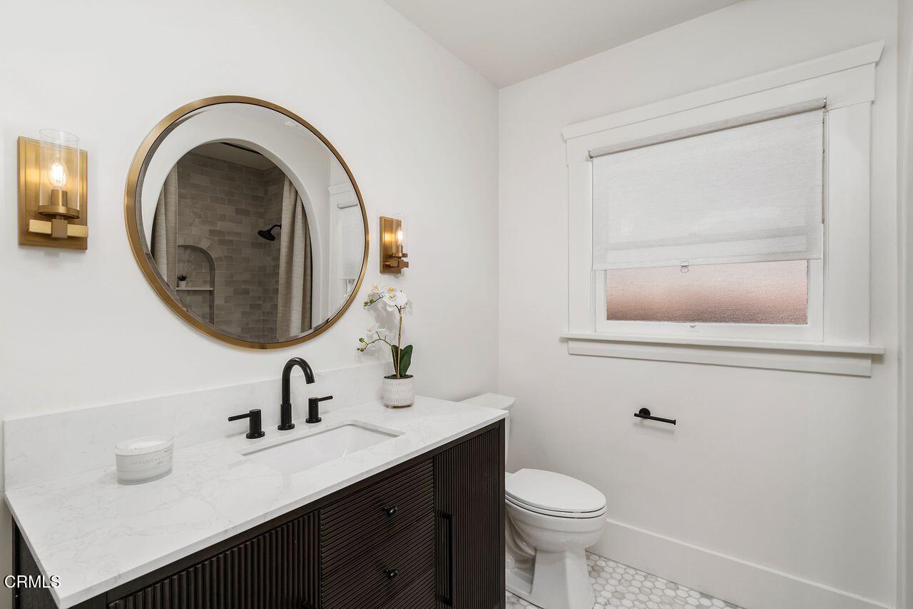 114 West 3rd Street San Dimas, CA 91773 - Photo 13 of 23 a bathroom with a toilet a sink and mirror