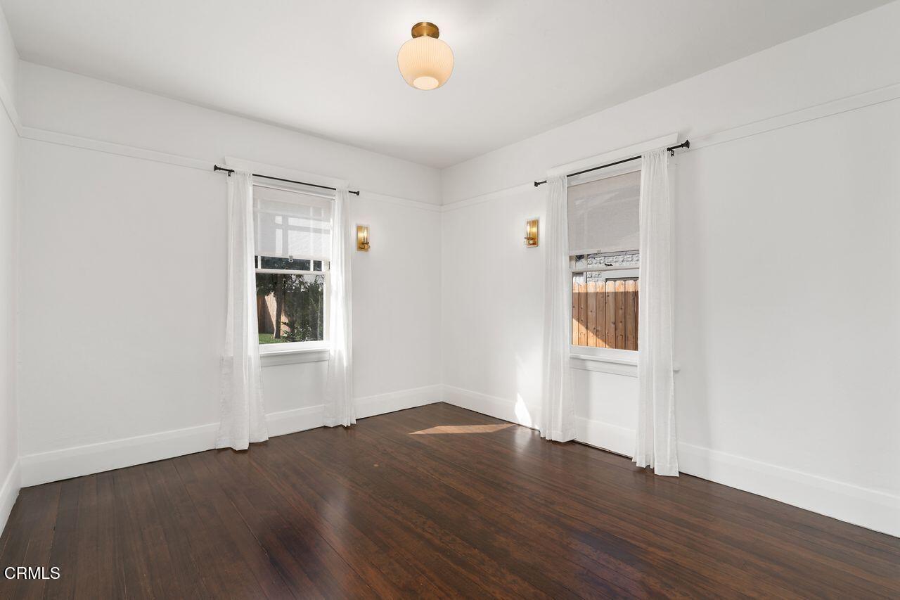 114 West 3rd Street San Dimas, CA 91773 - Photo 16 of 23 a view of an empty room with wooden floor and a window