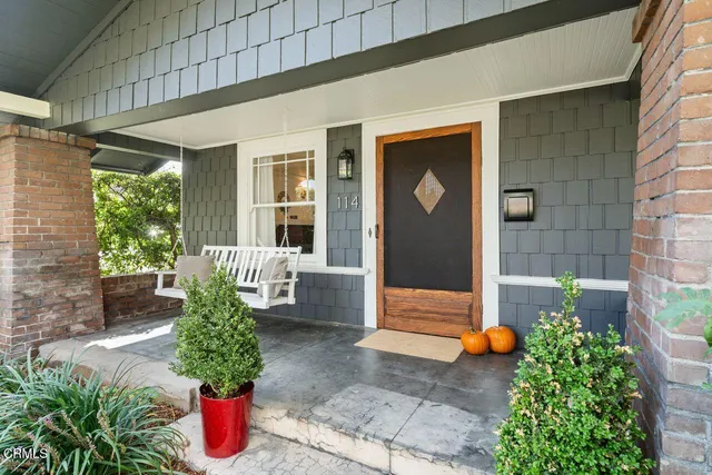 a front view of a house with plants