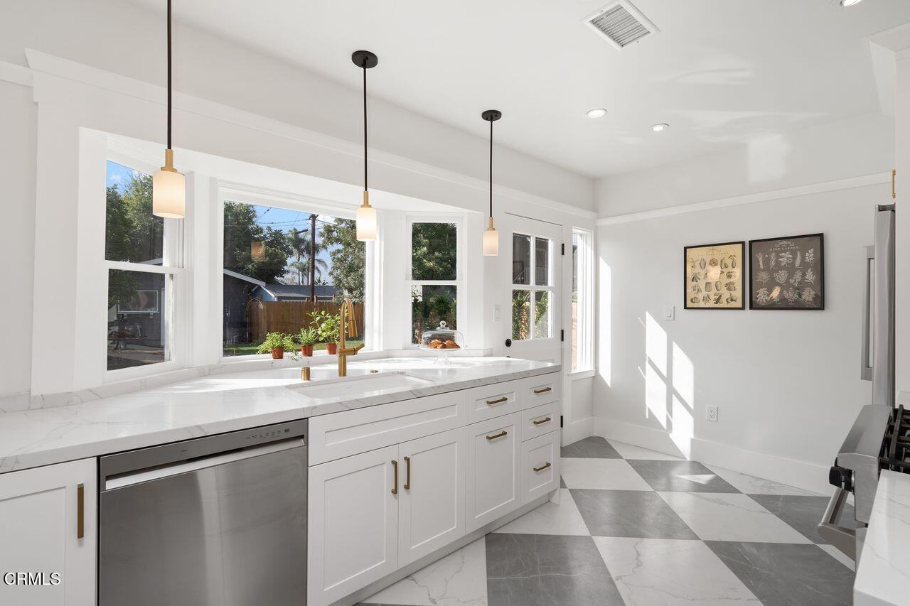 114 West 3rd Street San Dimas, CA 91773 - Photo 9 of 23 a kitchen with a sink window and cabinets