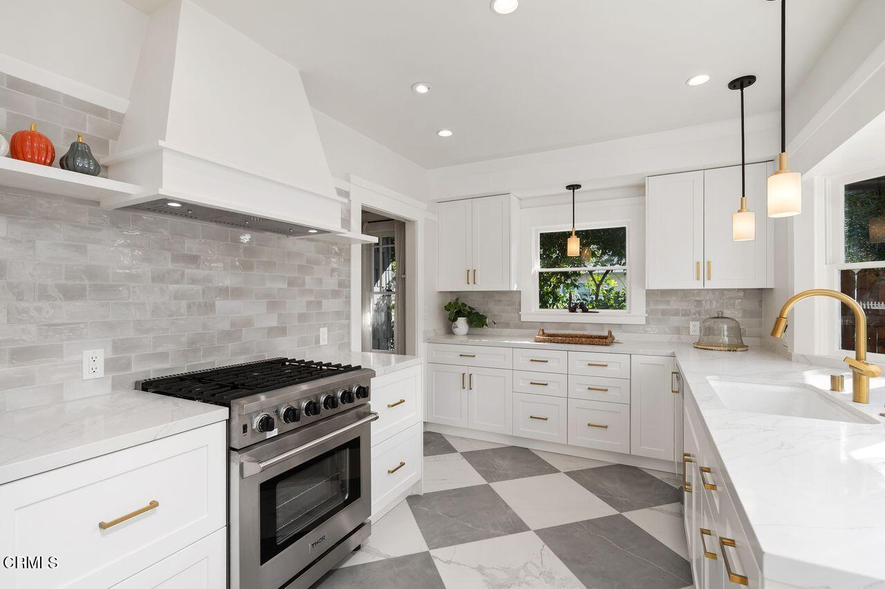 114 West 3rd Street San Dimas, CA 91773 - Photo 10 of 23 a kitchen with stainless steel appliances a stove a sink and a refrigerator
