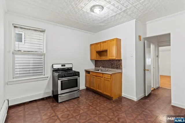 a kitchen with granite countertop a stove and a refrigerator