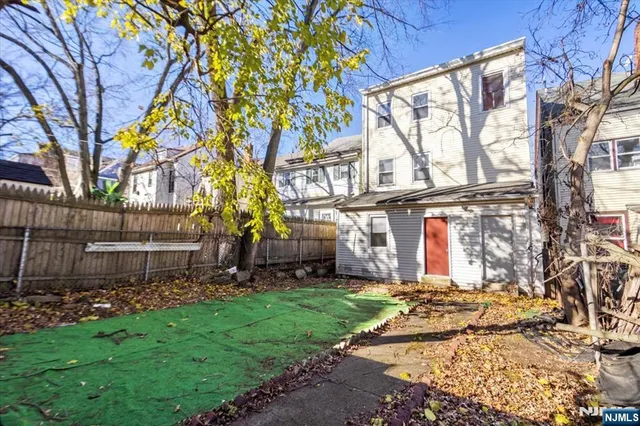 a view of backyard with a garden and trees