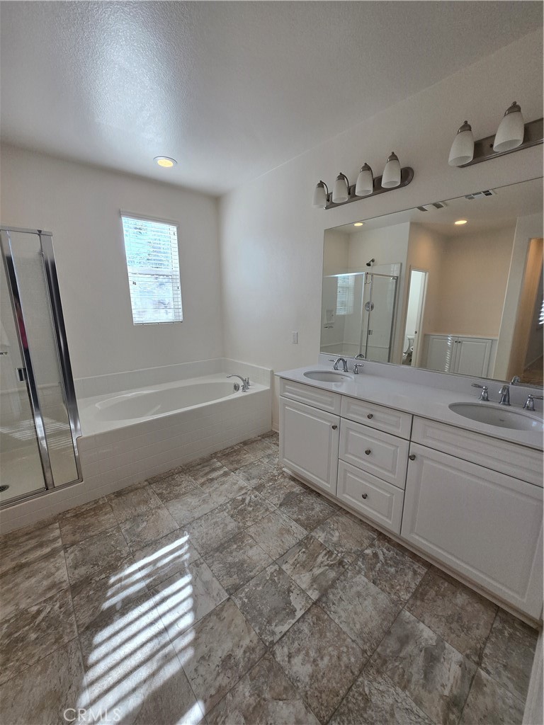 11014 Via Del Corso Riverside, CA 92505 - Photo 14 of 30 a bathroom with a double vanity sink a mirror and a