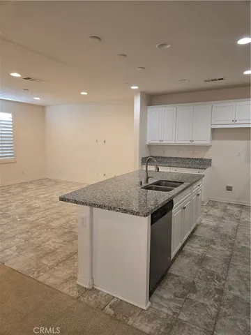 a kitchen with stainless steel appliances granite countertop a sink and a stove