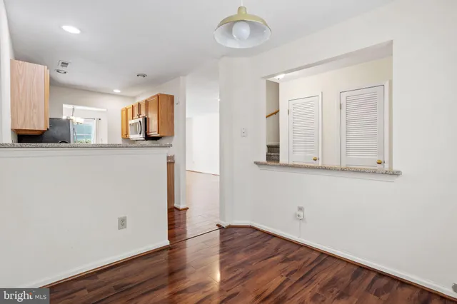 a view of a kitchen with wooden floor